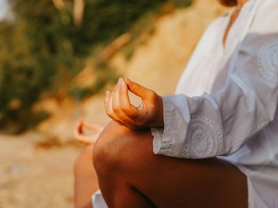 Close-up of hands in a meditative mudra position.